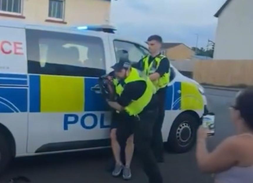 Police officer punching a biker.