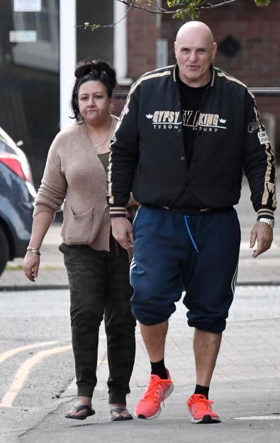Tommy Fury walking with his parents.