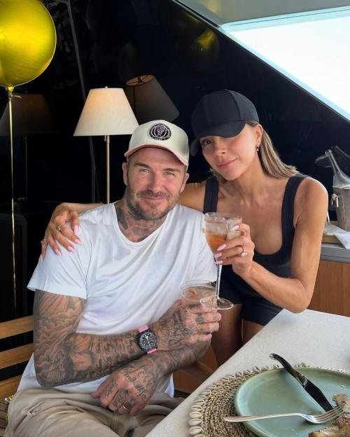Victoria and David Beckham celebrating on a yacht.
