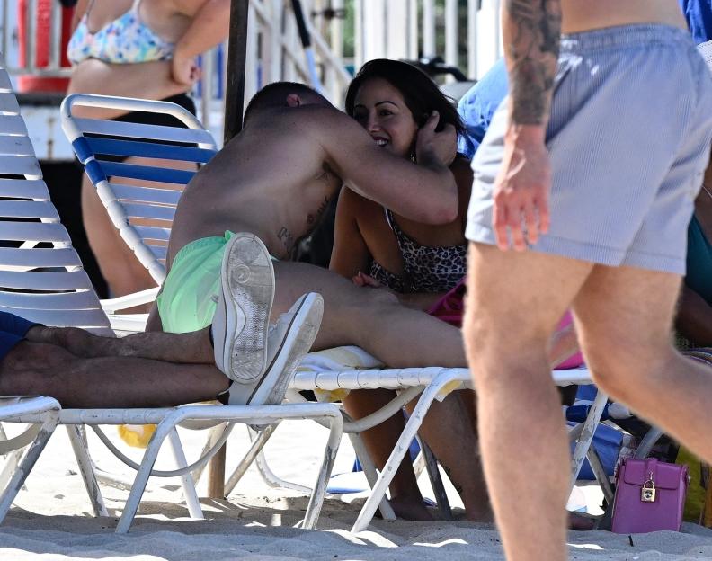 Conor McGregor and a woman sitting at a table.