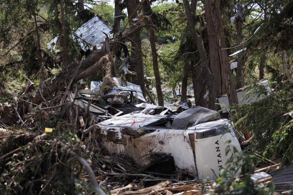 Damaged RV in flood debris.
