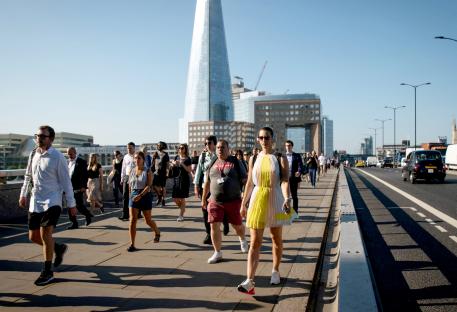 Commuters walking across London Bridge.