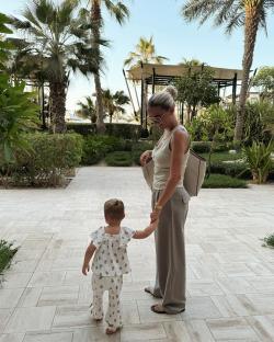 Woman and toddler holding hands in Dubai.