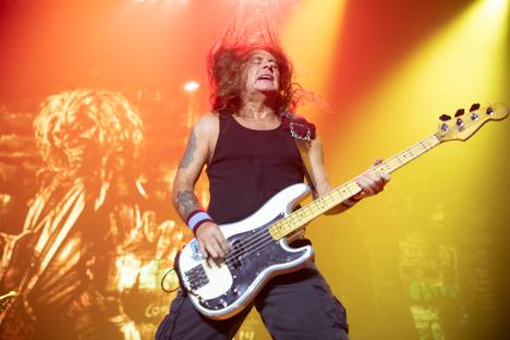 Steve Harris of Iron Maiden performing on stage.