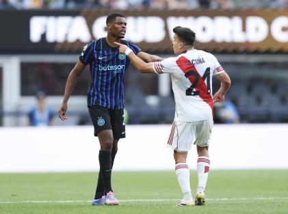 Soccer players arguing on the field.