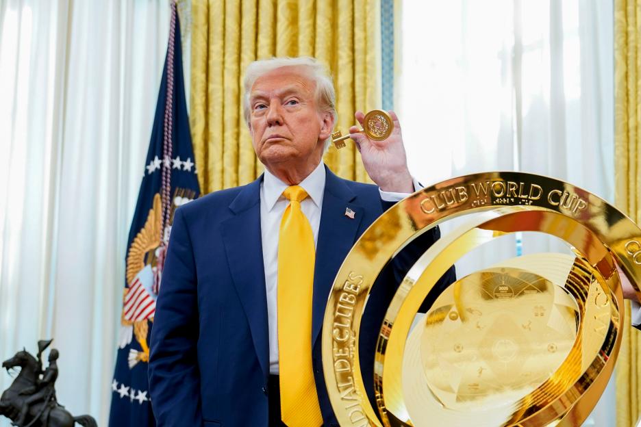 President Trump holding the FIFA Club World Cup trophy.