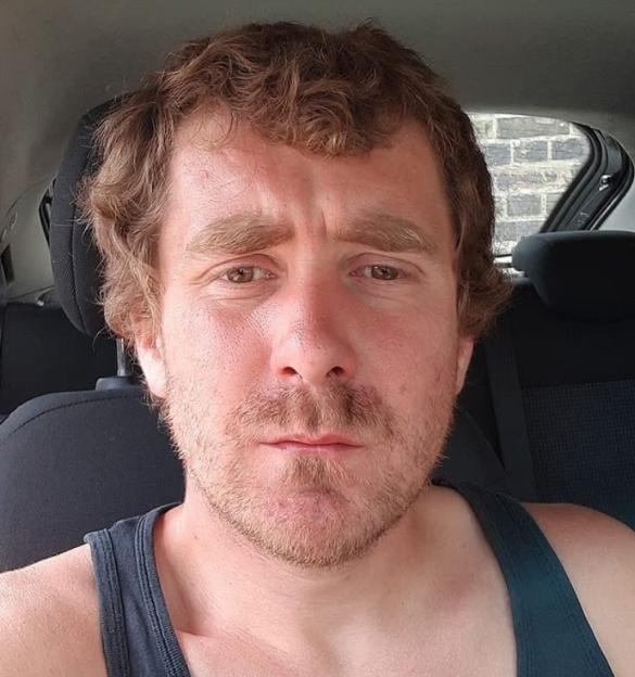 Close-up selfie of a man in a car.
