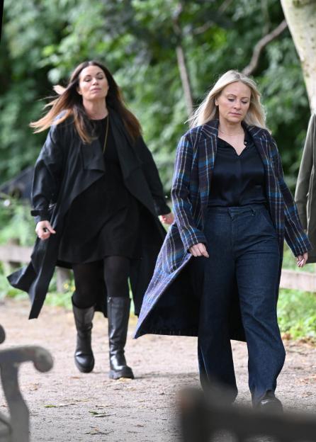 Two women walking in a park.