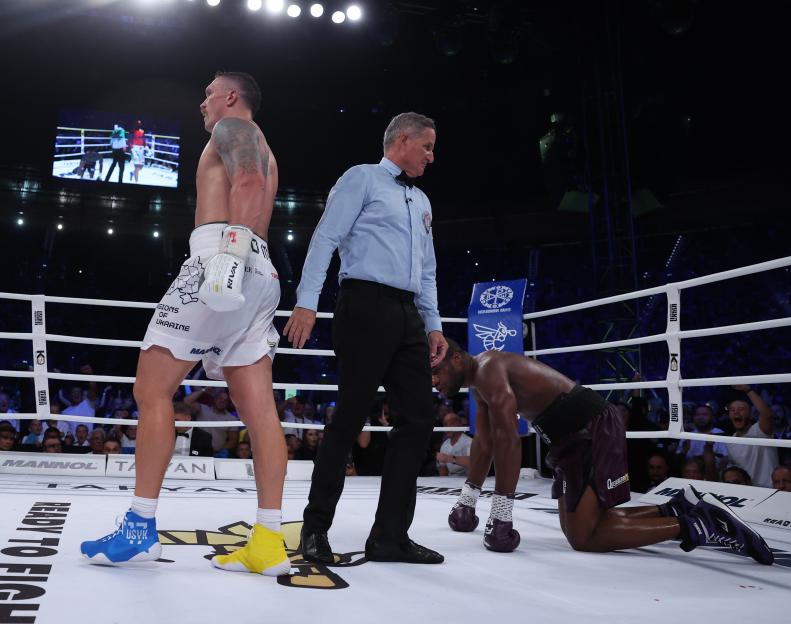 Oleksandr Usyk knocks down Daniel Dubois in a boxing match.
