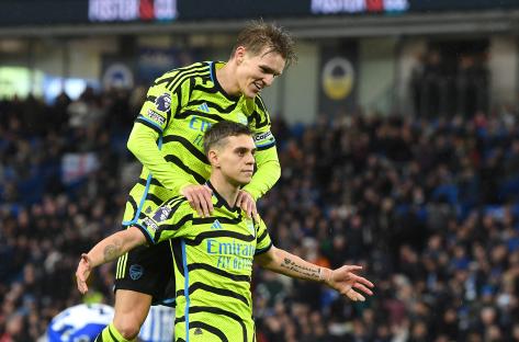 Leandro Trossard and Martin Odegaard of Arsenal celebrating a goal.