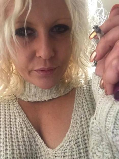 Woman holding a cigarette.