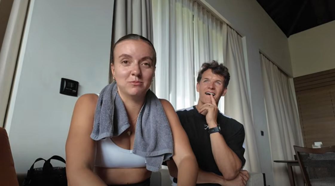 A woman and man sitting indoors.