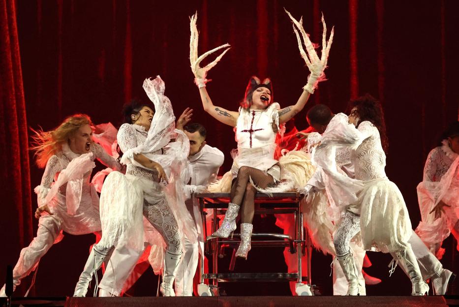 Lady Gaga performing on stage with dancers.