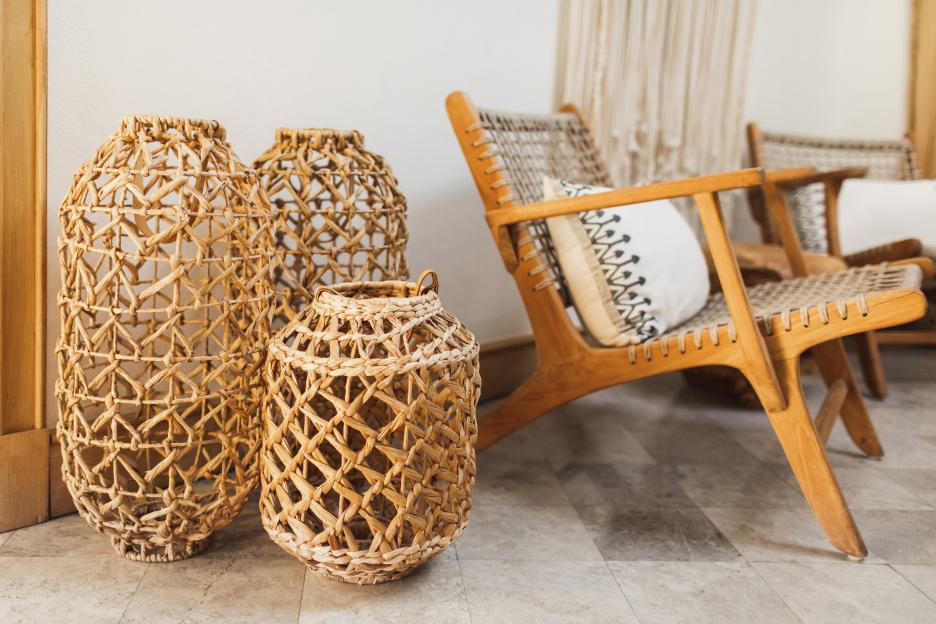 Wicker baskets and wooden chair in a room.
