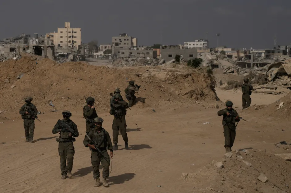 Soldiers walking through a war-torn area.
