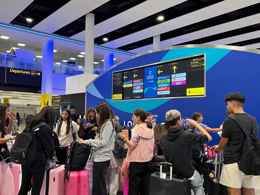 Passengers at an airport departures area.