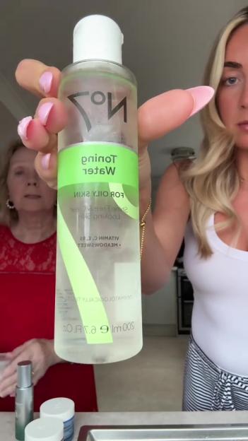 Woman holding a bottle of No7 toning water.