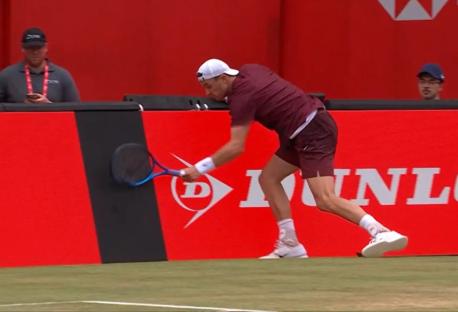 Tennis player reaching for a low shot.