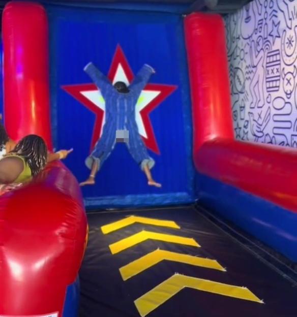Person stuck on inflatable playground star.