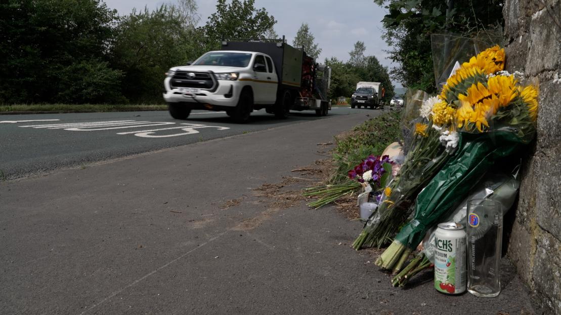 Tributes at a roadside following a fatal hit and run.