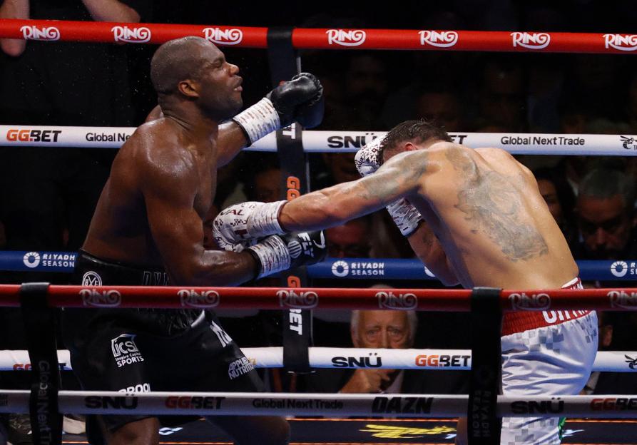Oleksandr Usyk knocks down Daniel Dubois in a boxing match.