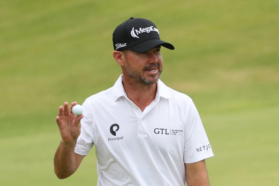 Brian Harman holding a golf ball.