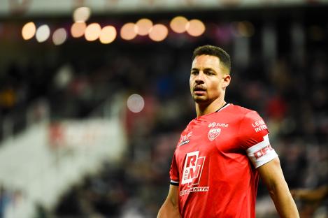 Soccer player Daniel Congre in a red Dijon FCO jersey.