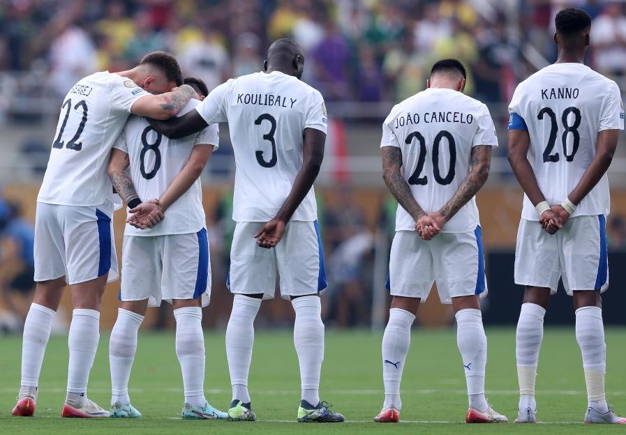 Al Hilal soccer players observe a moment of silence.