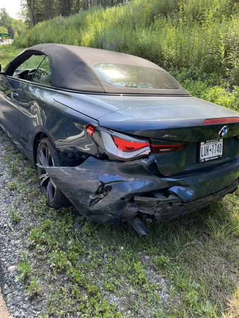 Damaged dark-grey BMW convertible.