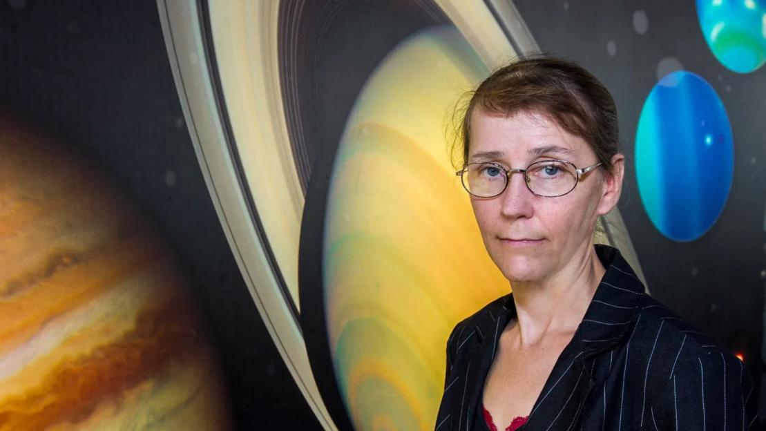 Portrait of Catharine Conley in front of a background depicting planets and space.