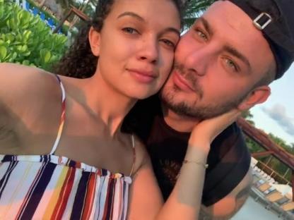 A woman and man embracing on vacation.