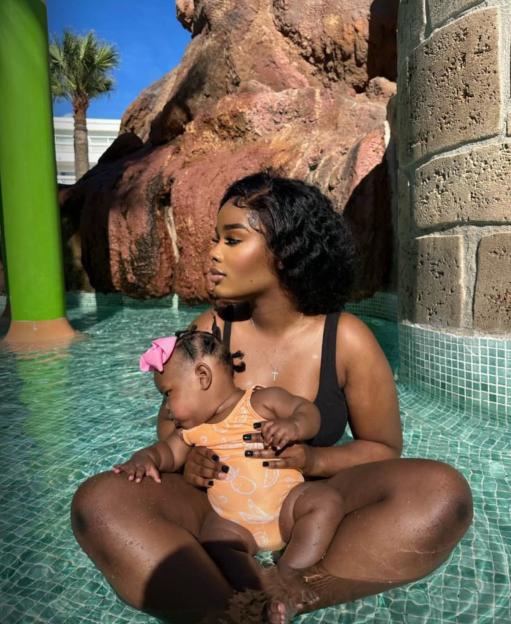 A mother and her young daughter in a swimming pool.