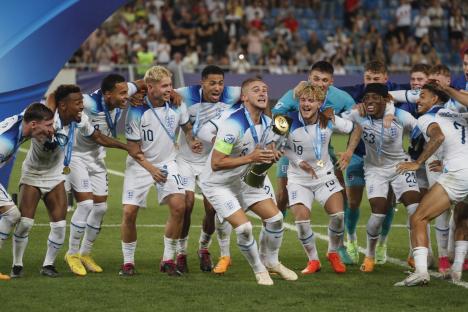 Taylor Harwood-Bellis of England lifts the UEFA Under-21 Euro 2023 trophy.