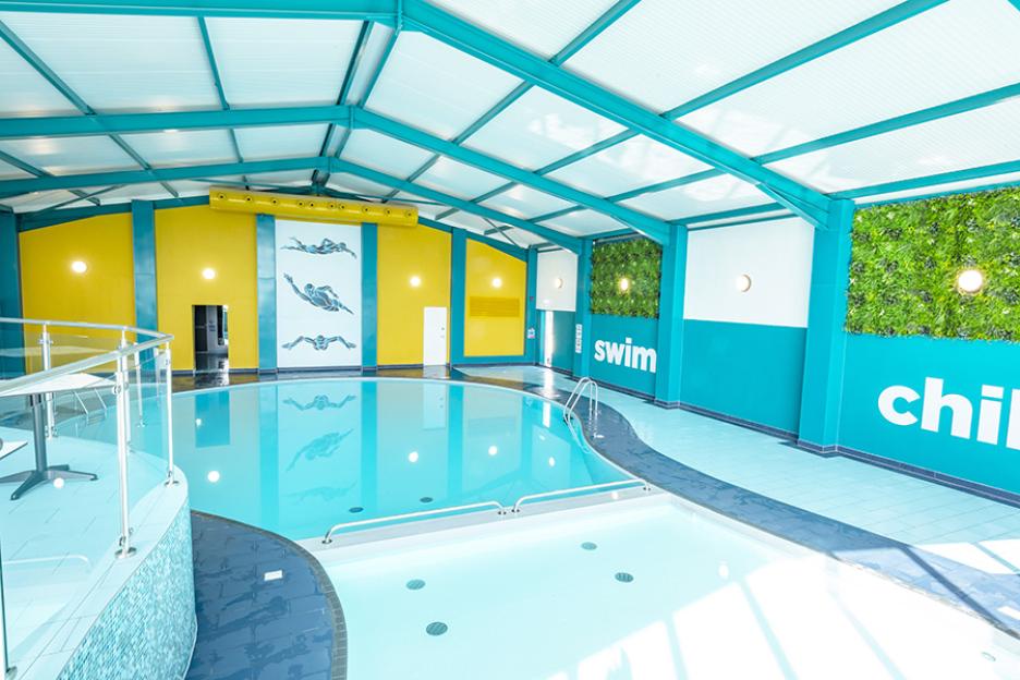 Indoor swimming pool with a shallow end for children.