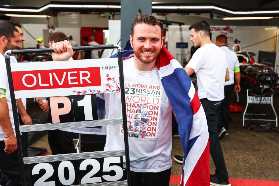 Oliver Rowland, 2025 World Champion, celebrating with a British flag.