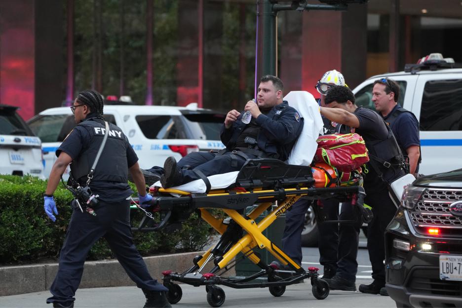 Police officer being wheeled on a gurney after a shooting.