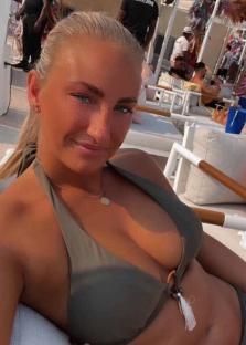 Woman in olive green bikini top at a beach club.