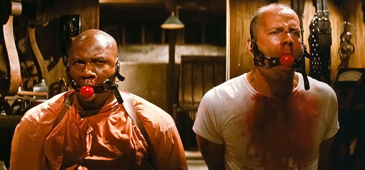 Scene from Pulp Fiction showing Bruce Willis and Ving Rhames gagged.