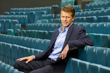 Andrew Castle, broadcaster and retired tennis player, sitting in stadium seats.
