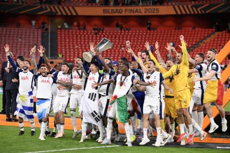 TOPSHOT - Tottenham Hotspur's South Korean forward #07 Son Heung-min raises the trophy as he celebrates with teammates winning the UEFA Europa League final football match between Tottenham Hotspur and Manchester United at San Mames stadium in Bilbao on May 21, 2025. (Photo by Josep LAGO / AFP) (Photo by JOSEP LAGO/AFP via Getty Images)