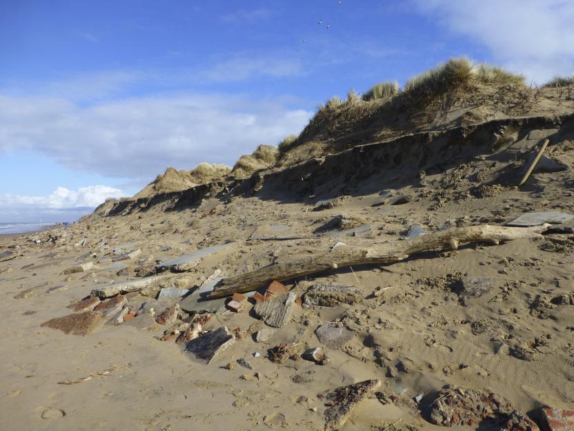 Beach erosion exposing building rubble.