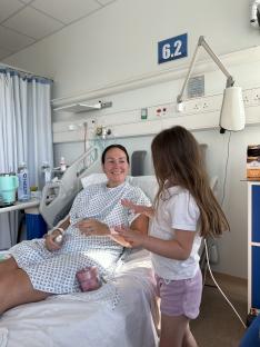 Woman in hospital bed with her daughter.
