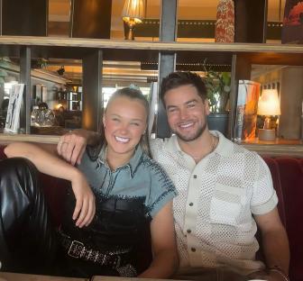 Photo of two smiling people sitting together.