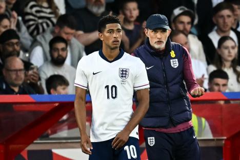 Jude Bellingham, England's midfielder #10, speaks with England's coach.