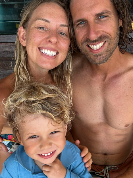 Family portrait: a woman, man, and young boy smiling.