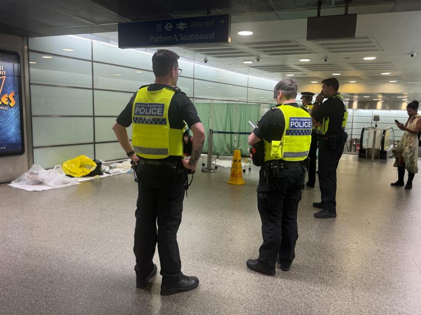 Police officers at St. Pancras International station investigating an incident.