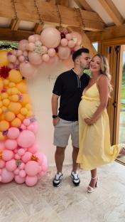 Pregnant woman and her partner at a baby shower.