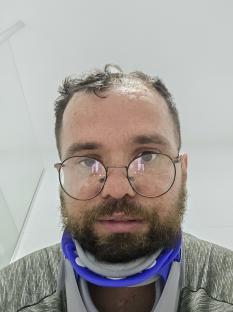 Man in neck brace with head wound.