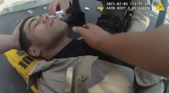 A man receiving medical attention at a crime scene.