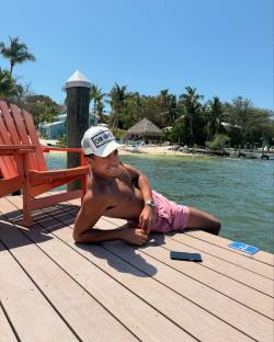 Harrison Solomon, Love Island bombshell, relaxing on a dock.